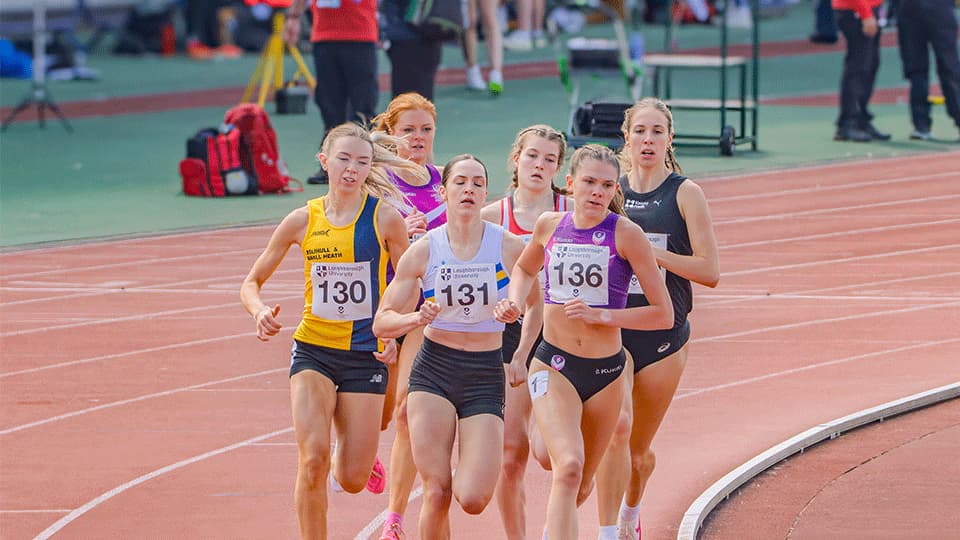 A group six women athletes running around a track at Loughborough's International Athletics May 2025