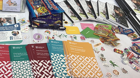 Leaflets and sweets in a display on a table