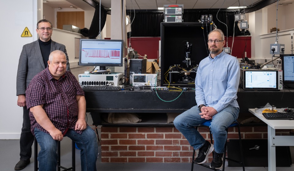 From left to right, Professor Alexander Balanov, Professor Sergey Saveliev, and Dr Pavel Borisov, of the Loughborough University Department of Physics. The team is pictured with the experimental setup used to capture how their artificial transneuron responded to electrical input, mimicking activity in different parts of the brain.