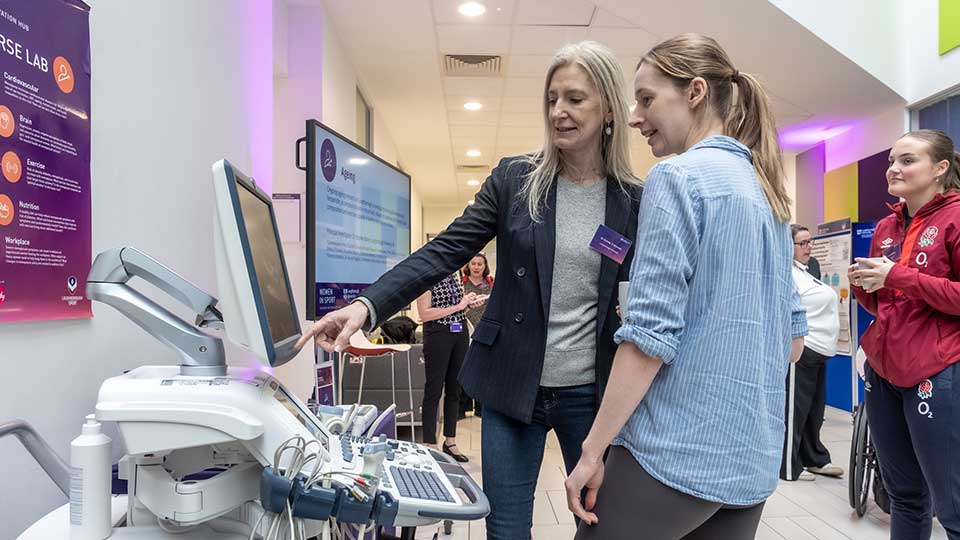 Two women discussing a piece of equipment