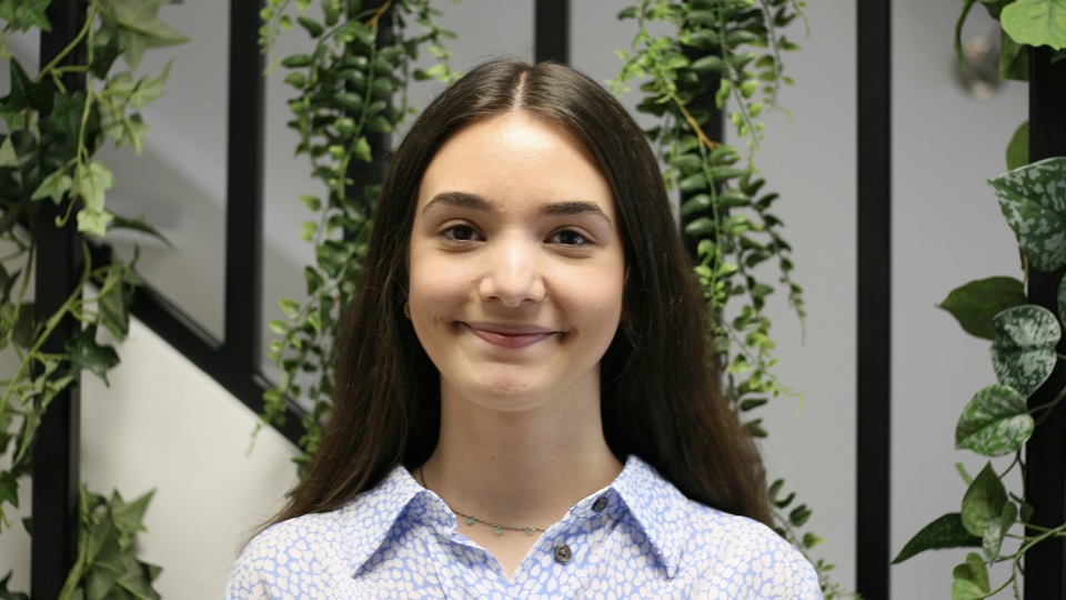A woman with long brown hair and blue shirt called Giuliana who has won an architecture award.