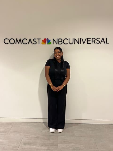 Nivetha standing in front of the sign for Comcast NBC Universal.