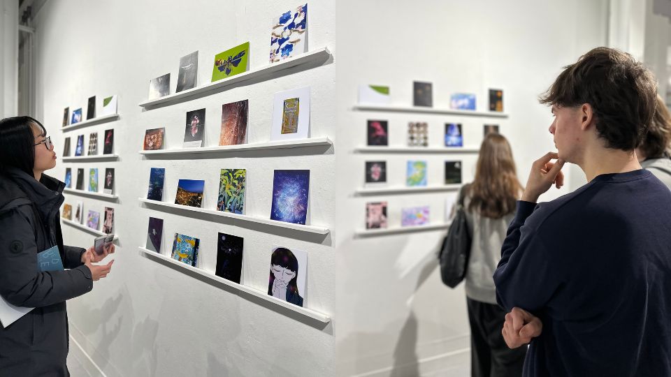Visitors looking at the scintilla postcards displayed on the walls