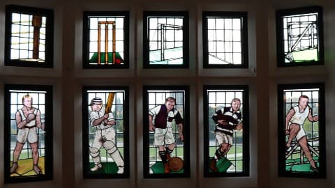 Stained glass bay windows in the Rutland building, displaying 1o panels with varying sport designs, circa 1932.
