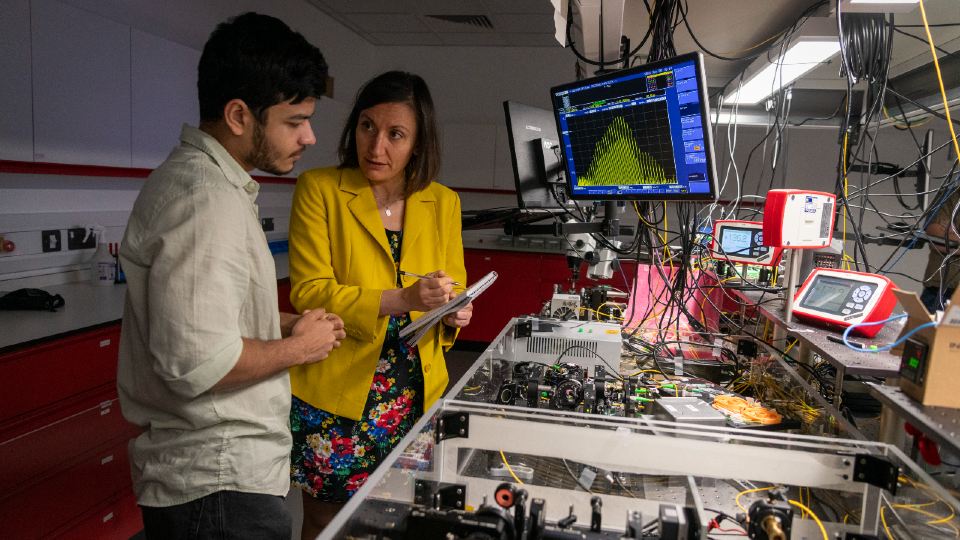 Two researchers in the Emergent Photonics Research Centre