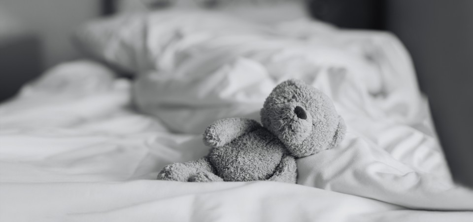 A teddy bear on a bed