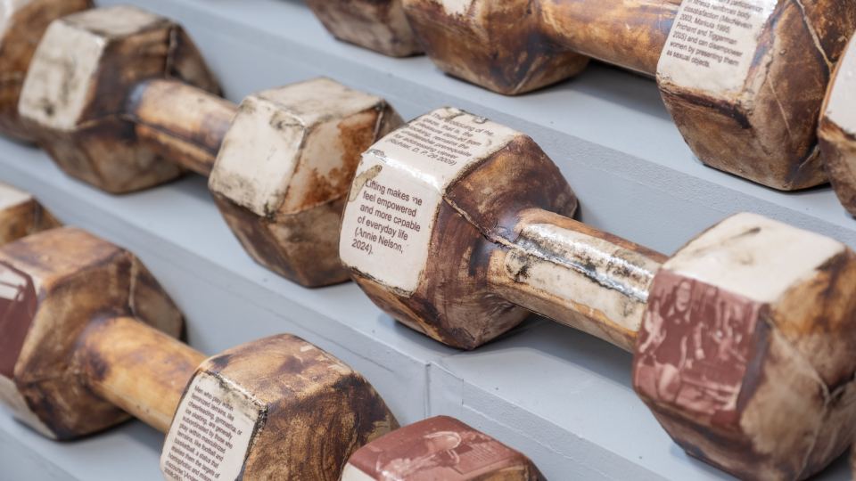 Ceramic dumbbells with quotes and photos transferred on their surface.