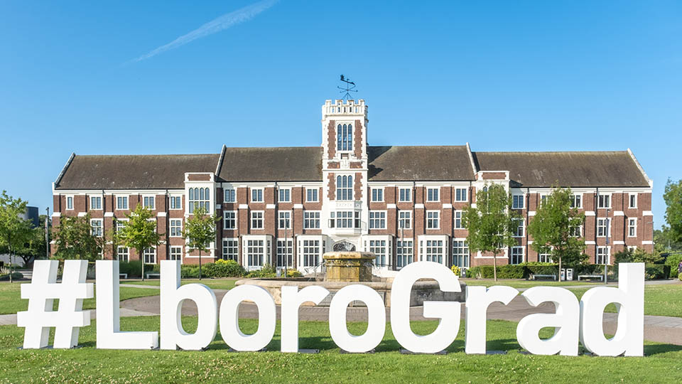 Hazlerigg Building and big white letters on the lawn that spell out #LboroGrad