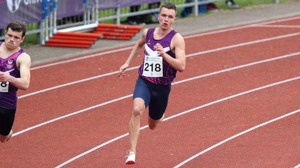 an athlete running round a track
