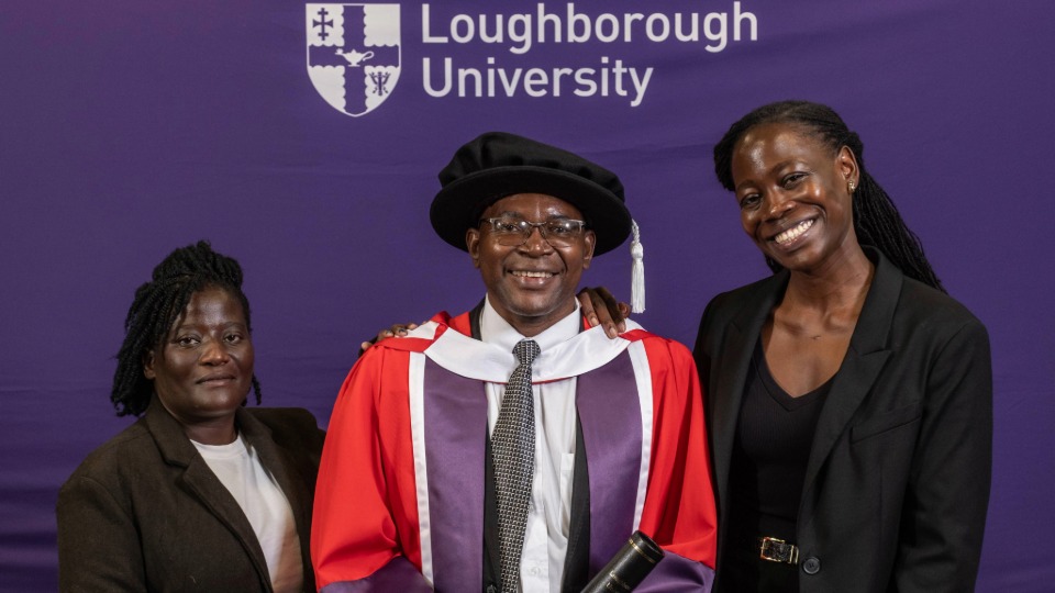 James stood in Doctor of the University graduate robes alongside family