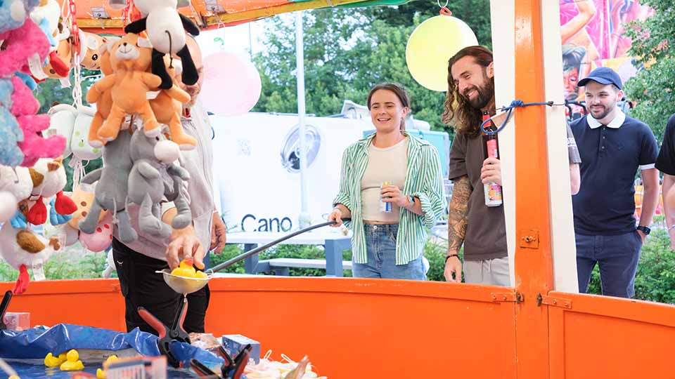 People playing a hook-a-duck game at the 2025 TUCO Summer Conference.