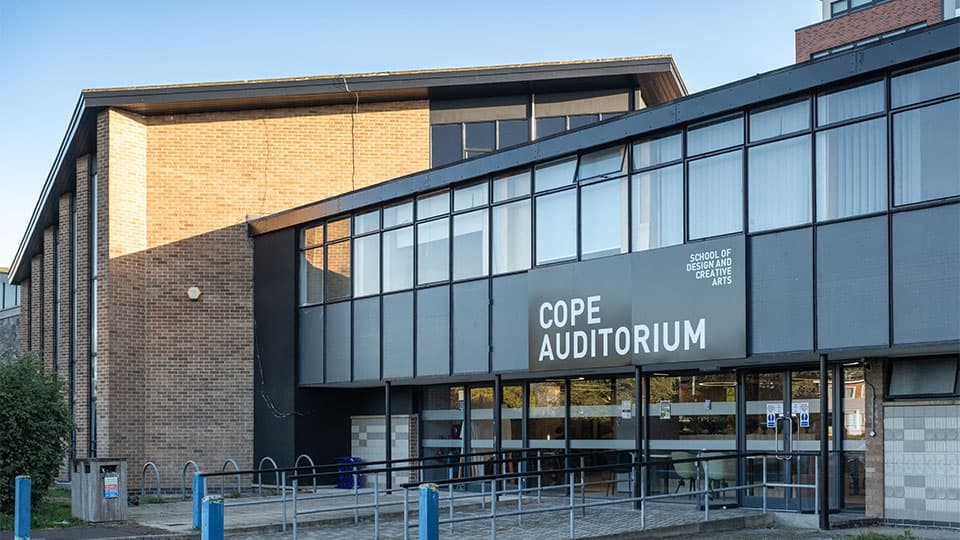 The new exterior of Cope Auditorium with a large new building name in an updated font