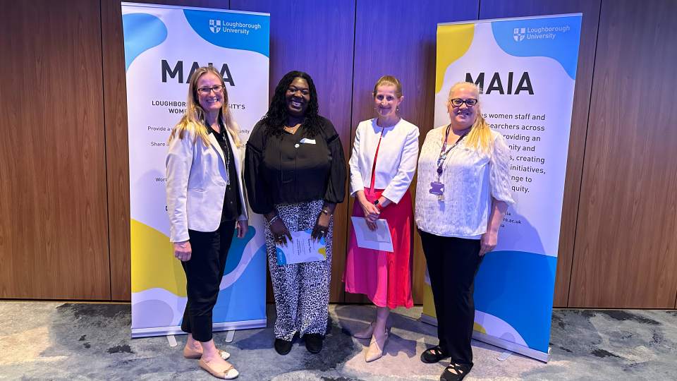 Maia co-chairs Henrietta Pocock and Gemma Towle standing in front of Maia banners with network sponsors, Professor Rachel Thomson and Veronica Moore.